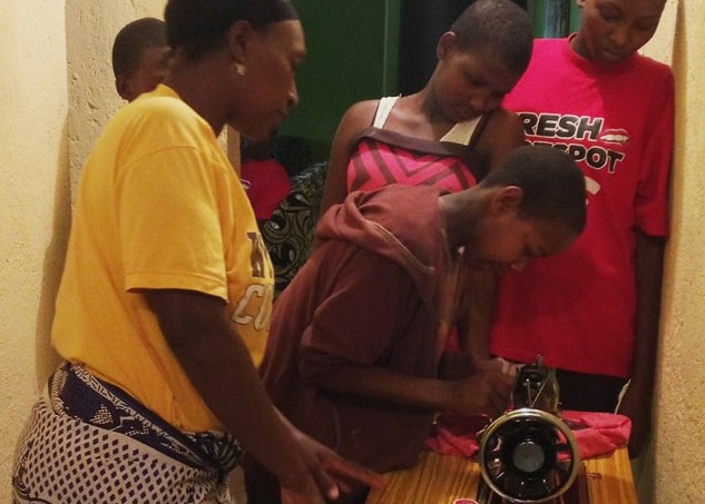 Girls learning to sew at the Wadada House